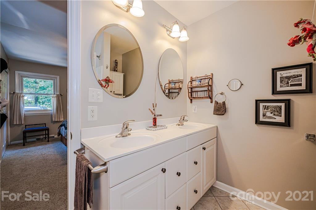 23055 Point Clear Drive, Unit 5 Tega Cay, SC 29708 - Photo 23 of 45 a bathroom with a double vanity sink and a mirror