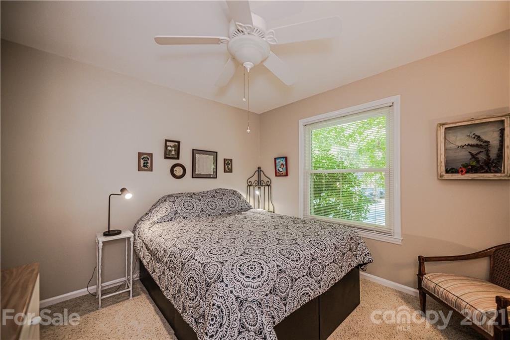 23055 Point Clear Drive, Unit 5 Tega Cay, SC 29708 - Photo 25 of 45 a bed sitting in a bedroom next to a window