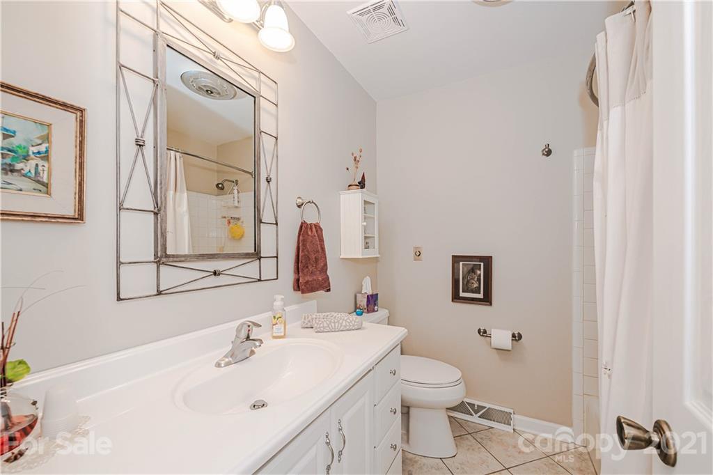 23055 Point Clear Drive, Unit 5 Tega Cay, SC 29708 - Photo 27 of 45 a bathroom with a sink toilet and shower