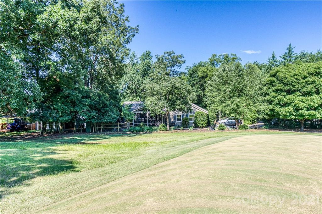 23055 Point Clear Drive, Unit 5 Tega Cay, SC 29708 - Photo 38 of 45 a view of a tennis ground with trees in the background