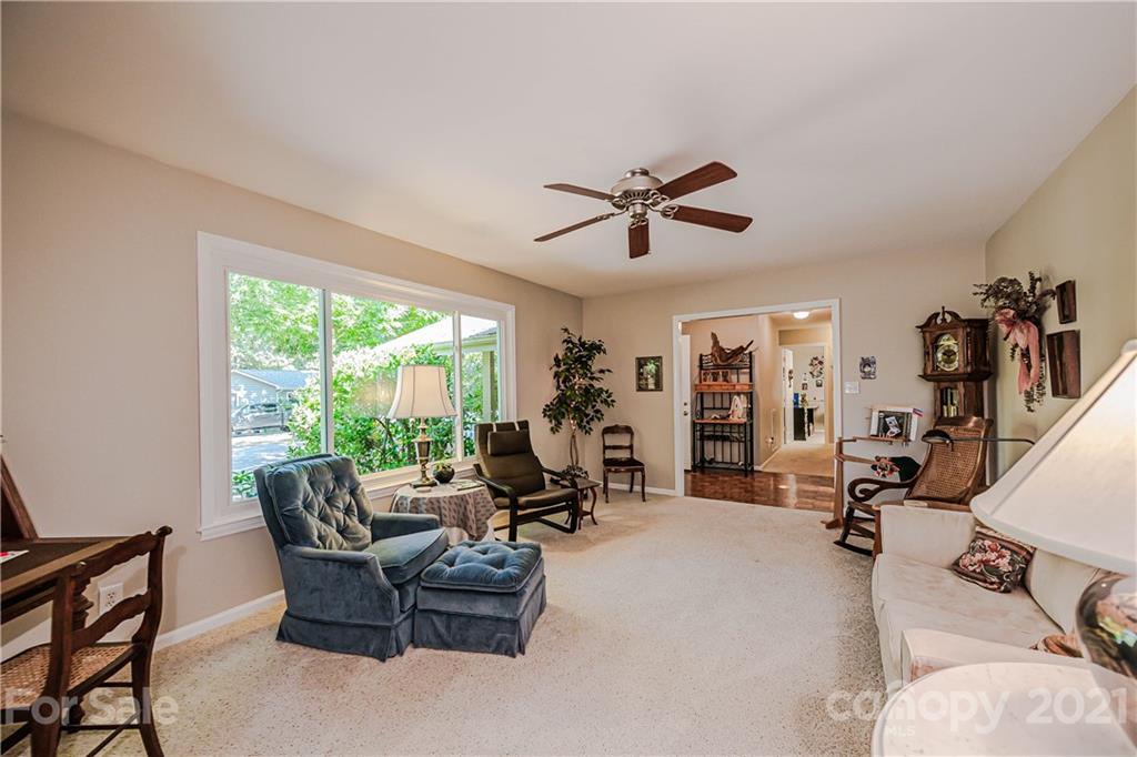 23055 Point Clear Drive, Unit 5 Tega Cay, SC 29708 - Photo 10 of 45 a living room with furniture large window and gym equipment