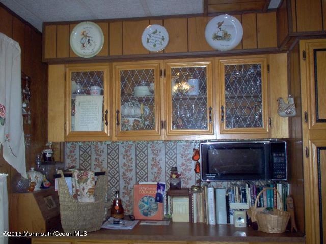 113 Village Road Morganville, NJ 07751 - Photo 2 of 7 a living room with lots of furniture and a clock
