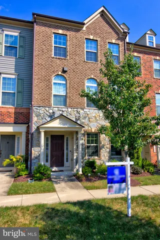 a front view of a house with yard and green space