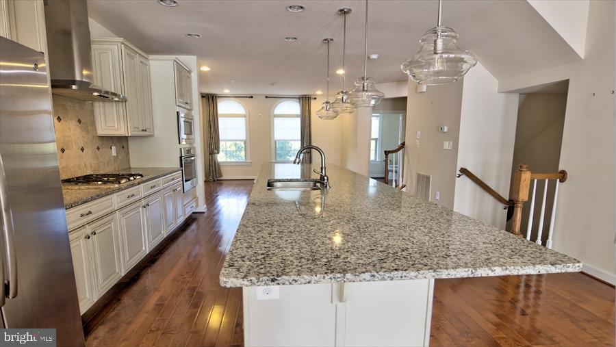 7652 Telamon Way Hanover, MD 21076 - Photo 11 of 34 a kitchen with stainless steel appliances granite countertop a sink dishwasher stove and refrigerator