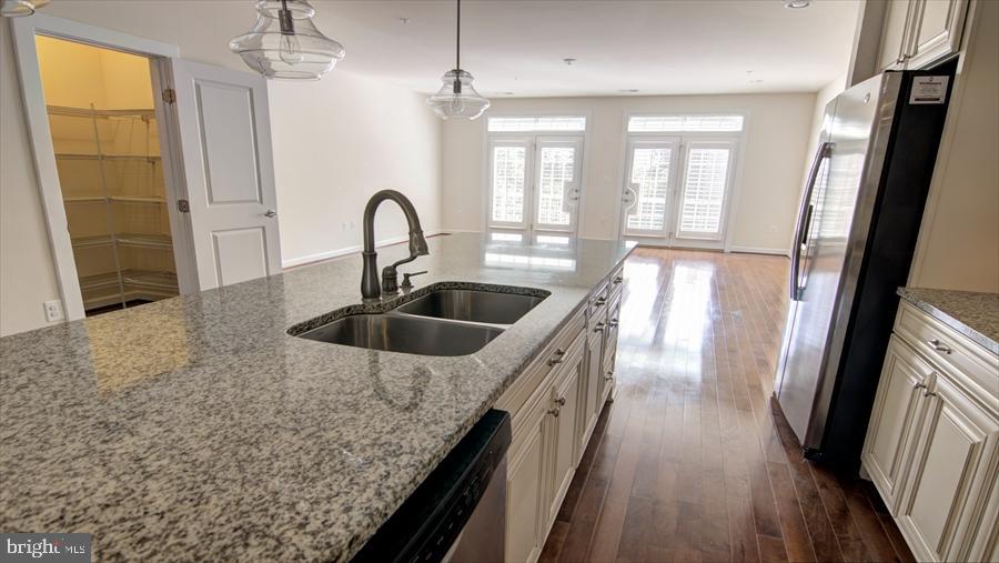 7652 Telamon Way Hanover, MD 21076 - Photo 12 of 34 a view of a sink a faucet a window and wooden floor