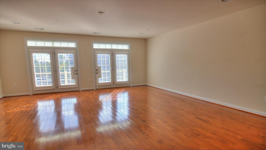 7652 Telamon Way Hanover, MD 21076 - Photo 17 of 34 a view of an empty room with wooden floor and a window