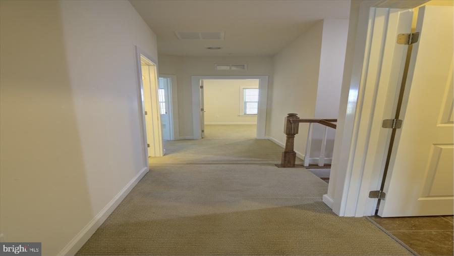 7652 Telamon Way Hanover, MD 21076 - Photo 20 of 34 a view of a hallway with wooden floor and cabinet