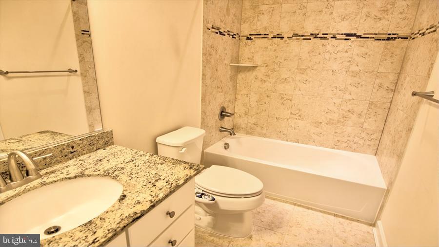 7652 Telamon Way Hanover, MD 21076 - Photo 8 of 34 a bathroom with a granite countertop sink toilet and shower