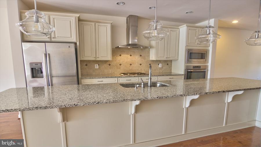 7652 Telamon Way Hanover, MD 21076 - Photo 10 of 34 a kitchen with stainless steel appliances granite countertop a sink and cabinets