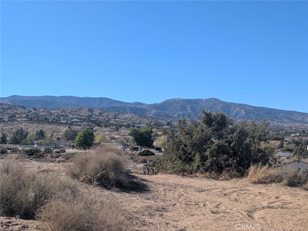 0 Malpaso Road Phelan, CA 92371 - Photo 5 of 19 a view of a dry field with mountains in the background