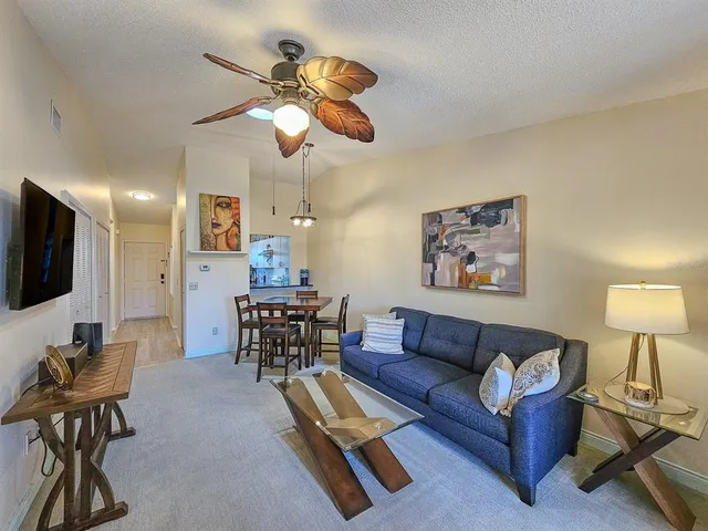 a living room with furniture a couch and a flat screen tv