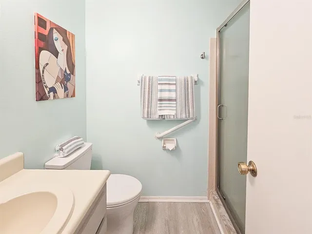 a white toilet sitting next to a bathroom sink and a tub