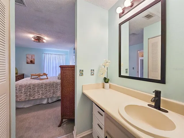 a en suite bathroom with a double vanity sink and a mirror