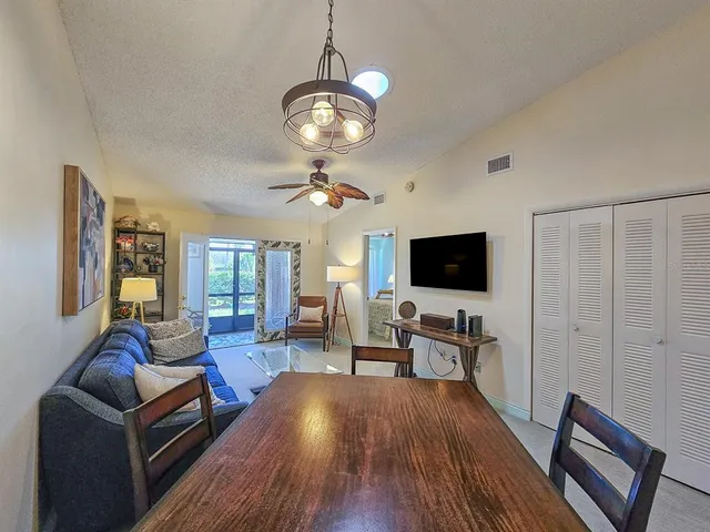 a living room with furniture or chandelier and a flat screen tv