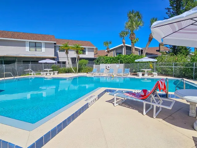 a view of outdoor kitchen with swimming pool and sitting area