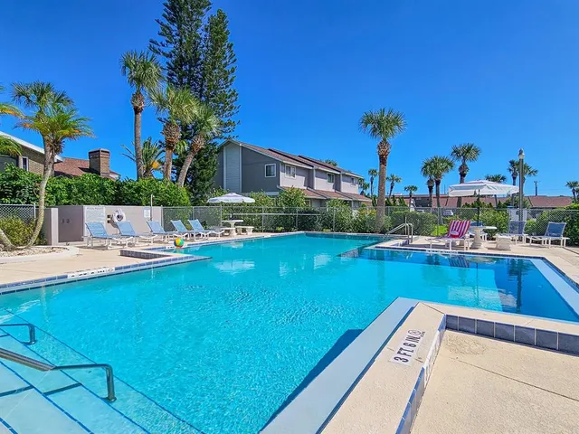 a view of swimming pool with outdoor seating and city view