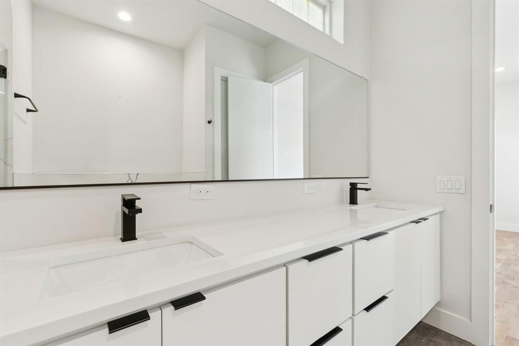 4119 Munger Avenue Dallas, TX 75204 - Photo 14 of 30 a bathroom with a sink and a mirror