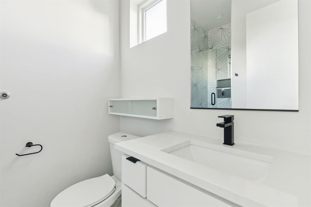 4119 Munger Avenue Dallas, TX 75204 - Photo 23 of 30 a bathroom with a sink a toilet and mirror
