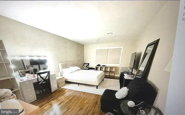 a bedroom with furniture and a wooden floor