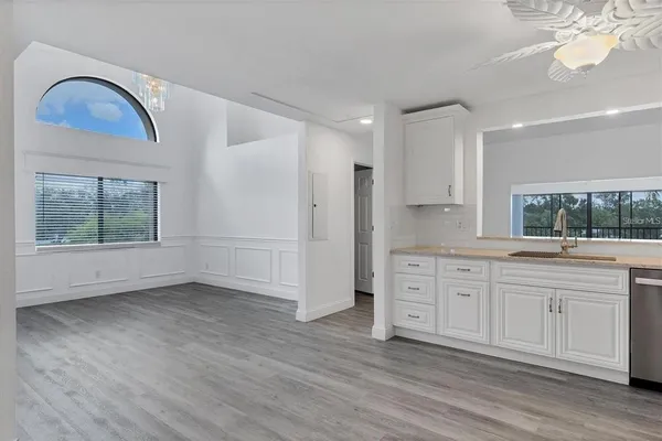 a view of a kitchen with a sink dishwasher and wooden floor