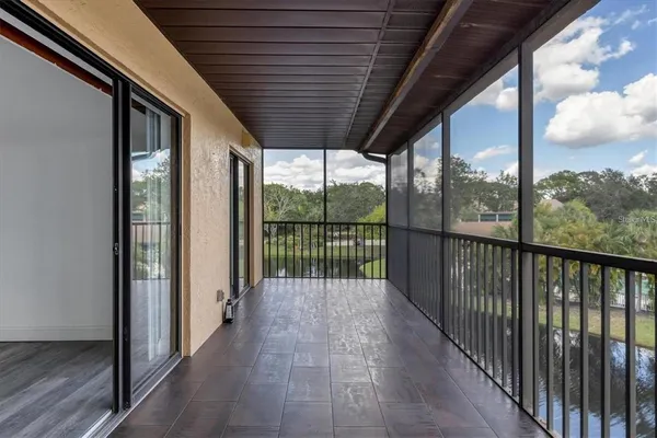 a view of a porch with wooden floor in front of a house