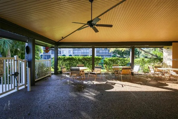 a view of a patio with a table and chairs under an umbrella