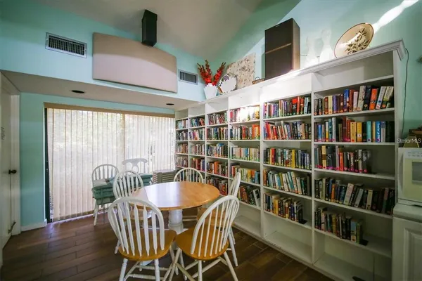 a dining room with furniture and wooden floor