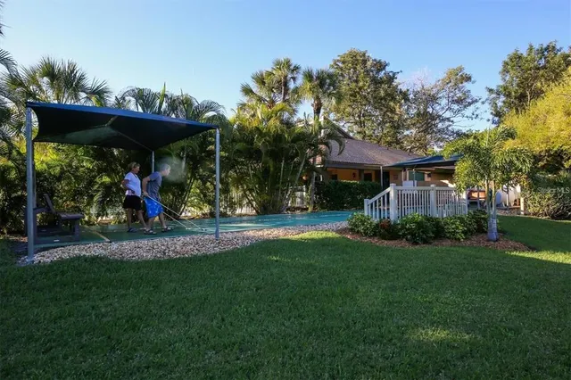 an aerial view of a house with a garden and lake view