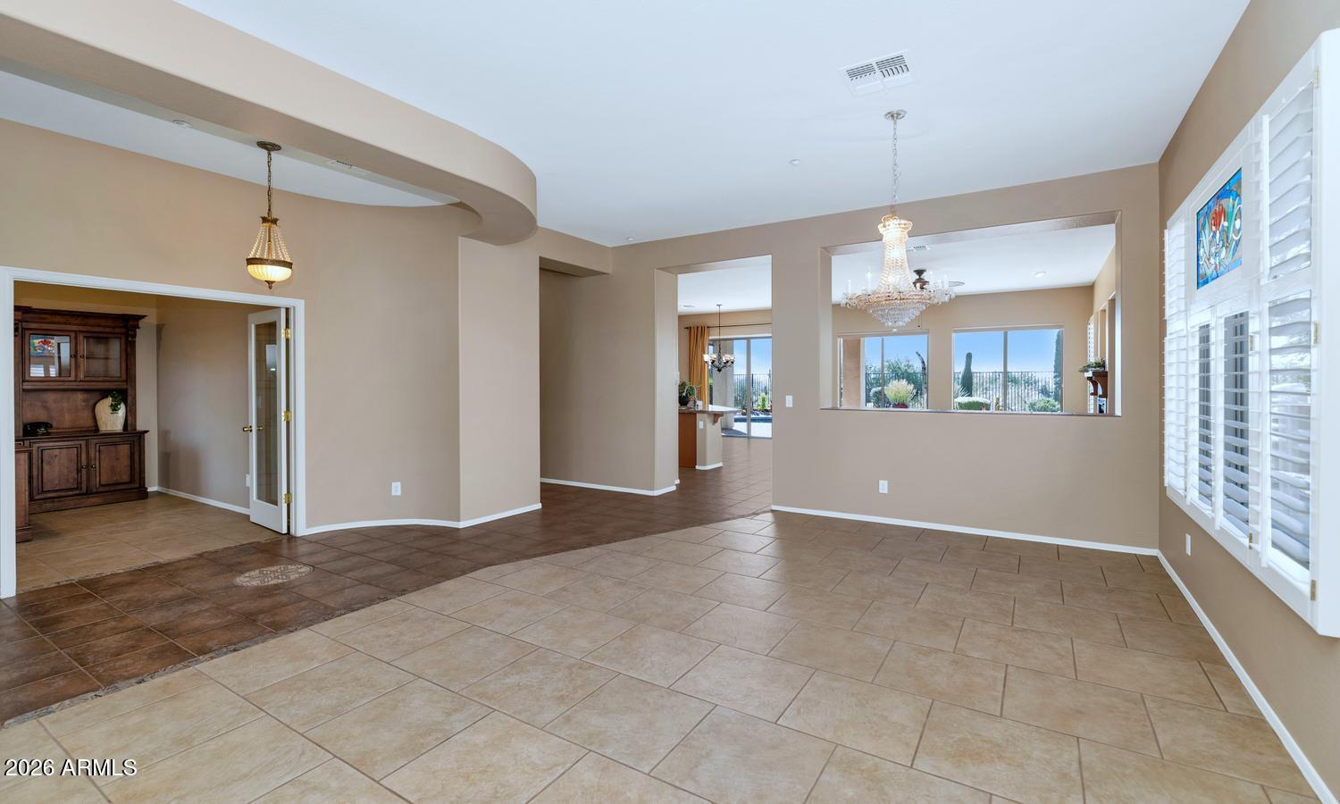 41123 North River Bend Road Phoenix, AZ 85086 - Photo 9 of 45 a view of a big room with windows and chandelier fan