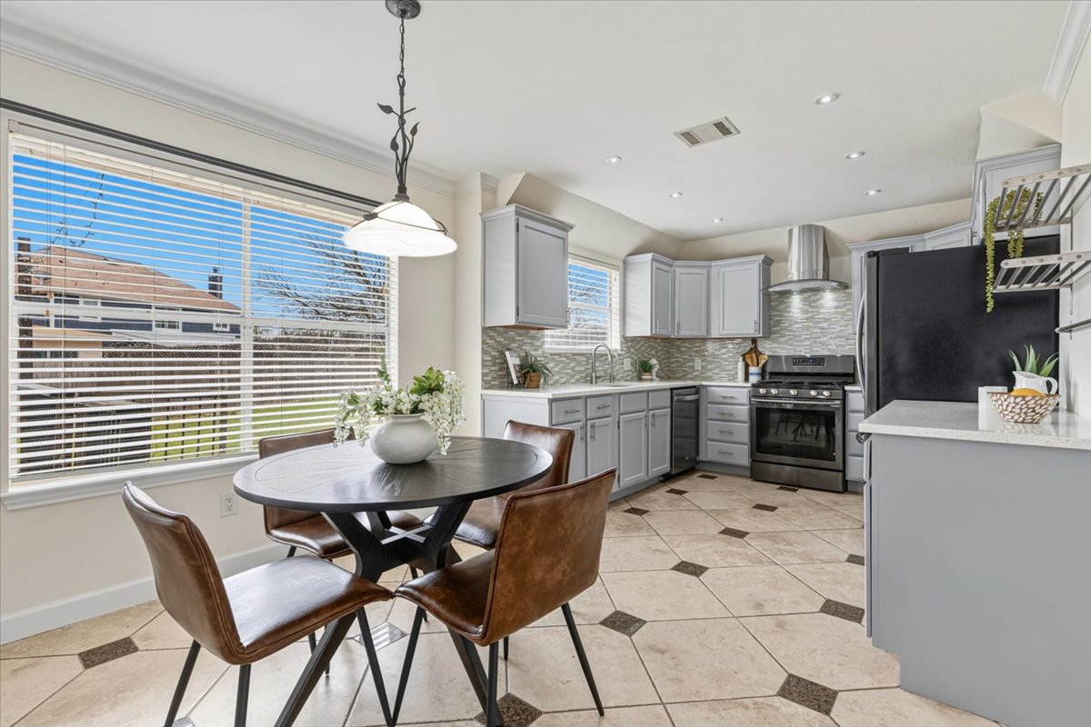 8103 Red Rock Cove Austin, TX 78749 - Photo 12 of 33 a kitchen with a table chairs and white cabinets