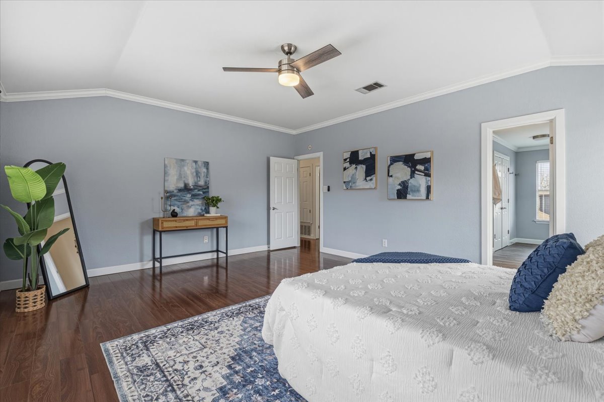 8103 Red Rock Cove Austin, TX 78749 - Photo 20 of 33 a bedroom with a bed and a chandelier