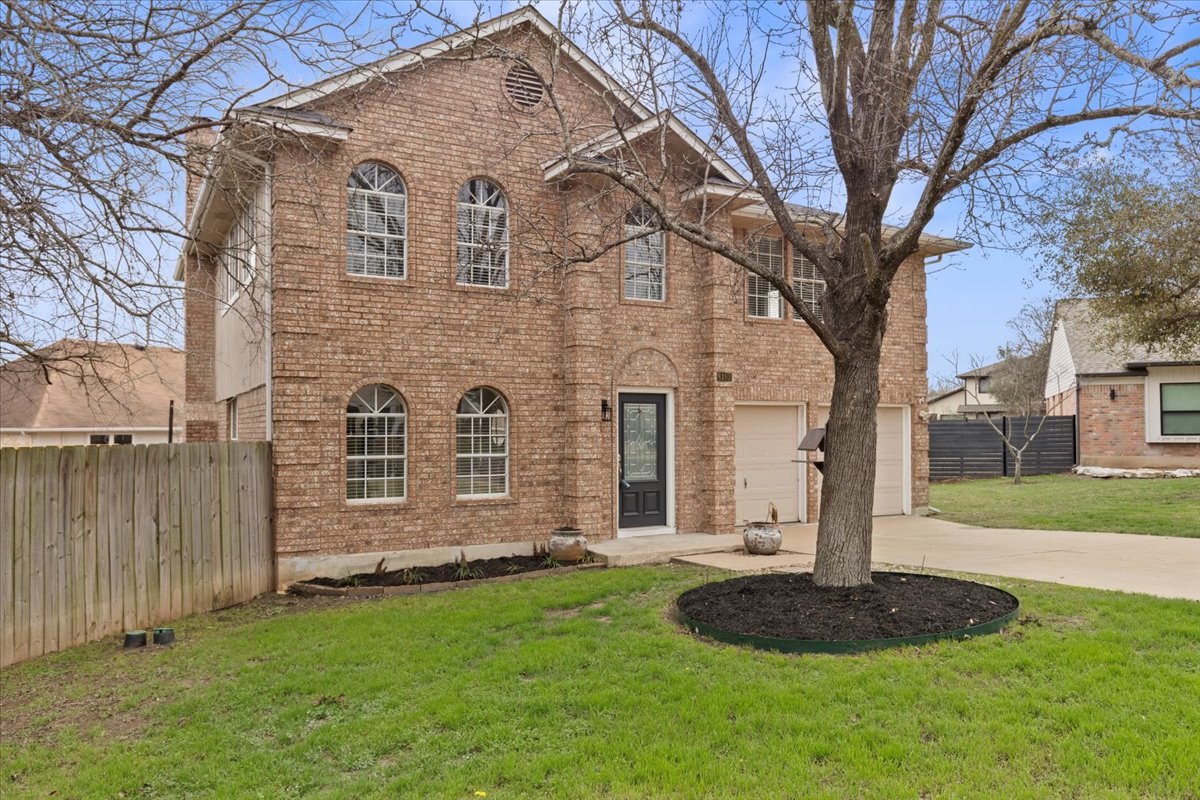 8103 Red Rock Cove Austin, TX 78749 - Photo 2 of 33 a front view of a house with a yard