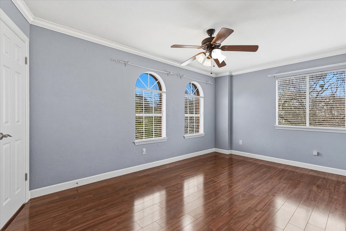 8103 Red Rock Cove Austin, TX 78749 - Photo 25 of 33 a view of an empty room with wooden floor and a window