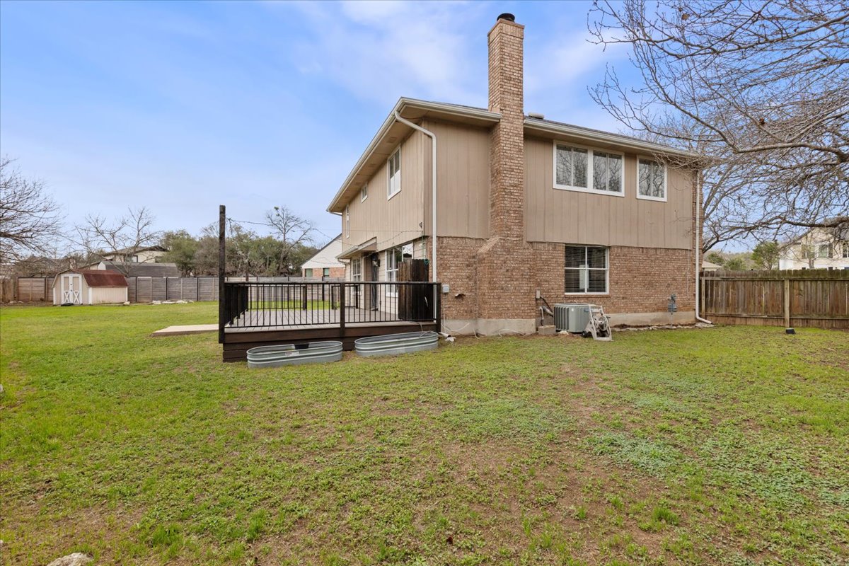 8103 Red Rock Cove Austin, TX 78749 - Photo 31 of 33 a view of a house with backyard and a tree