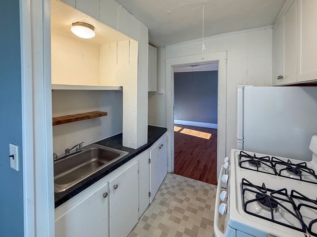 258-260 Main Street, Unit 2 Ashland, MA 01721 - Photo 5 of 10 a kitchen with a refrigerator and a stove
