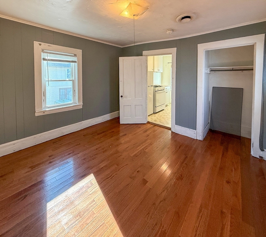 258-260 Main Street, Unit 2 Ashland, MA 01721 - Photo 8 of 10 an empty room with wooden floor and windows