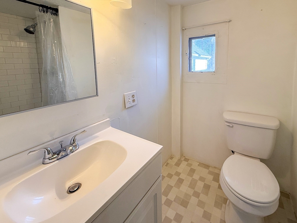 258-260 Main Street, Unit 2 Ashland, MA 01721 - Photo 9 of 10 a bathroom with a sink a toilet and shower