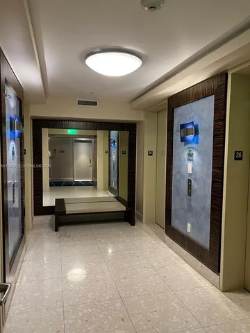 a view of an empty room with glass door and shower