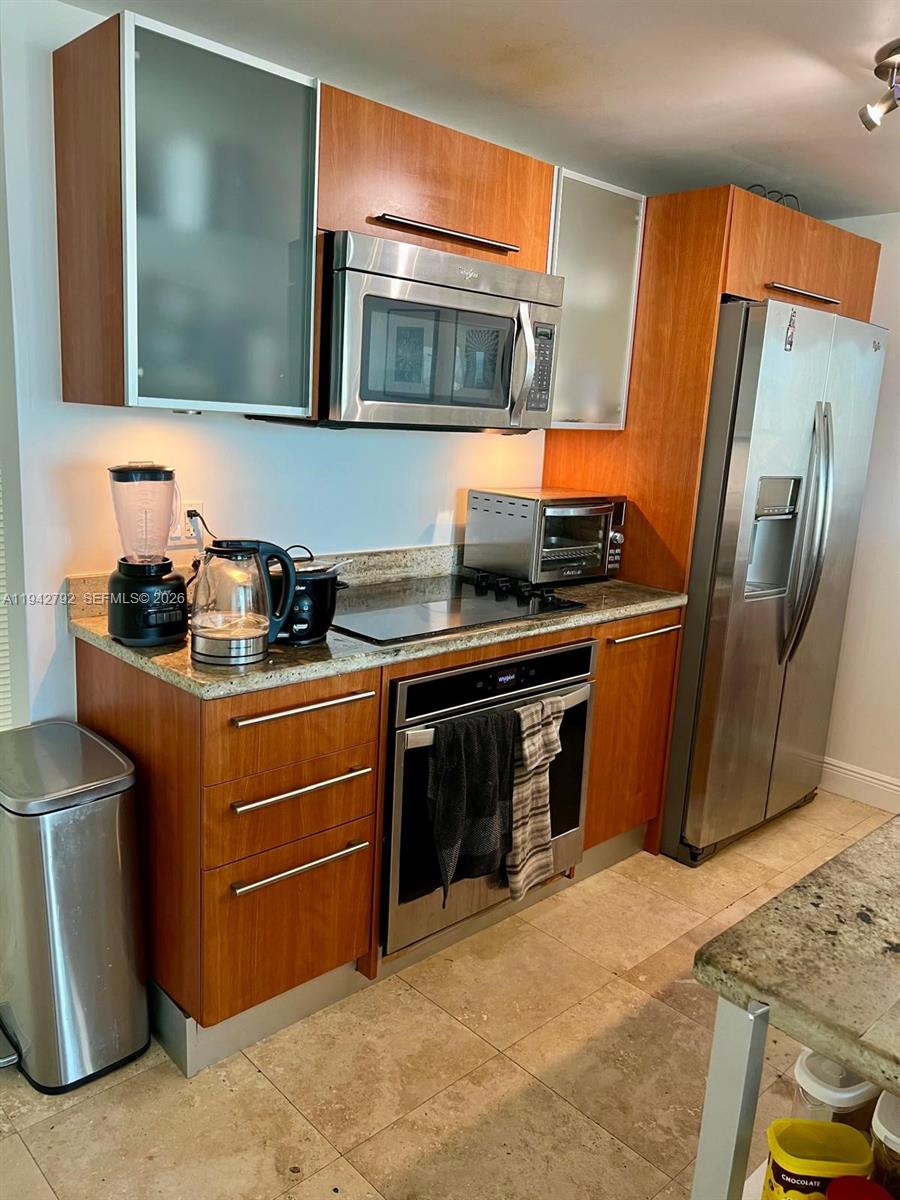 185 Southwest 7th Street, Unit 2601 Miami, FL 33130 - Photo 3 of 17 a kitchen with stainless steel appliances granite countertop a stove a refrigerator and a sink