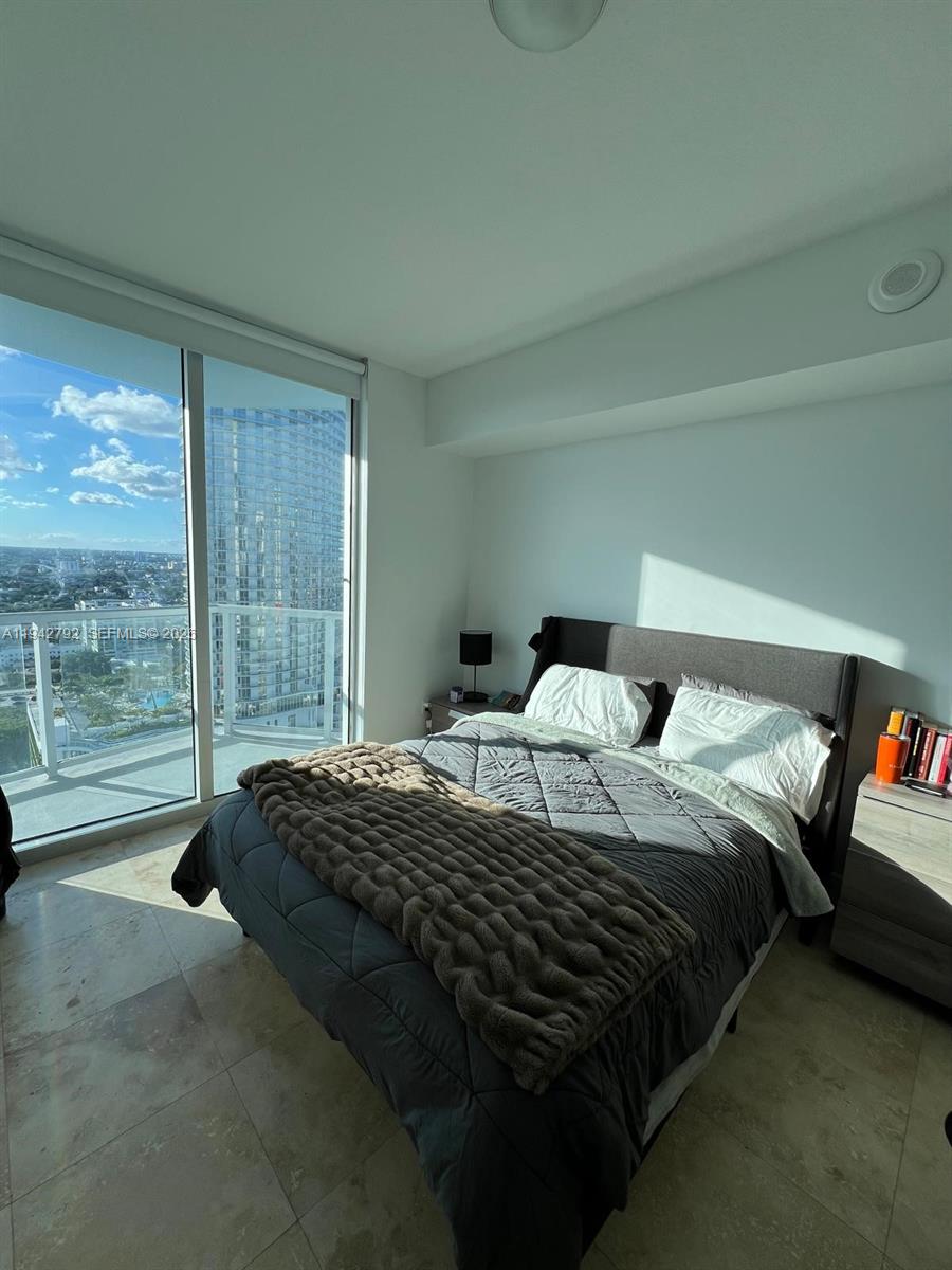 185 Southwest 7th Street, Unit 2601 Miami, FL 33130 - Photo 10 of 17 a bedroom with bed and glass door