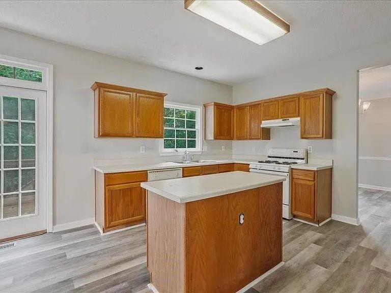 4382 Oakleaf Cove Decatur, GA 30034 - Photo 14 of 27 a kitchen with stainless steel appliances granite countertop a sink stove and refrigerator