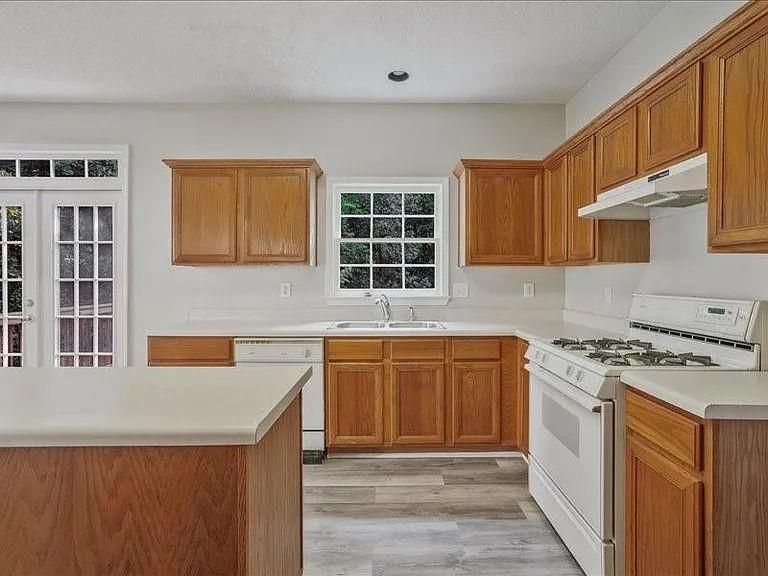 4382 Oakleaf Cove Decatur, GA 30034 - Photo 15 of 27 a kitchen with stainless steel appliances granite countertop a stove a sink and a microwave