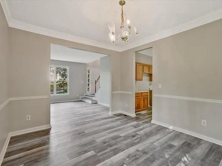 4382 Oakleaf Cove Decatur, GA 30034 - Photo 16 of 27 a view of a livingroom with wooden floor and a chandelier