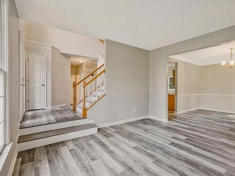 4382 Oakleaf Cove Decatur, GA 30034 - Photo 17 of 27 a view of an empty room with wooden floor and stairs