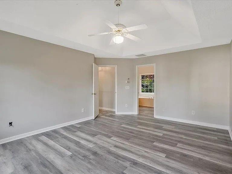 4382 Oakleaf Cove Decatur, GA 30034 - Photo 19 of 27 a view of an empty room with window and wooden floor