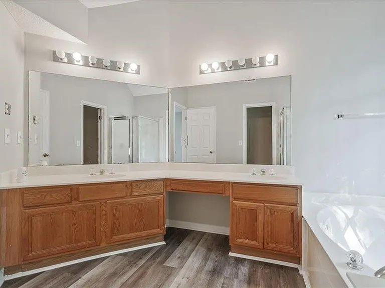 4382 Oakleaf Cove Decatur, GA 30034 - Photo 4 of 27 a spacious bathroom with a sink a large mirror and a bathtub