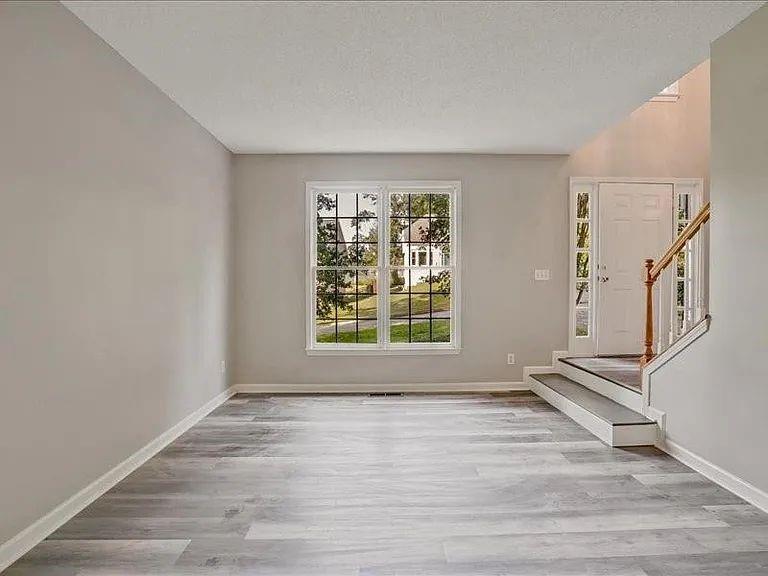 4382 Oakleaf Cove Decatur, GA 30034 - Photo 5 of 27 a view of an empty room with a window and wooden floor