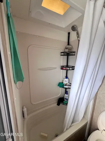 a bedroom with bed and a mirror