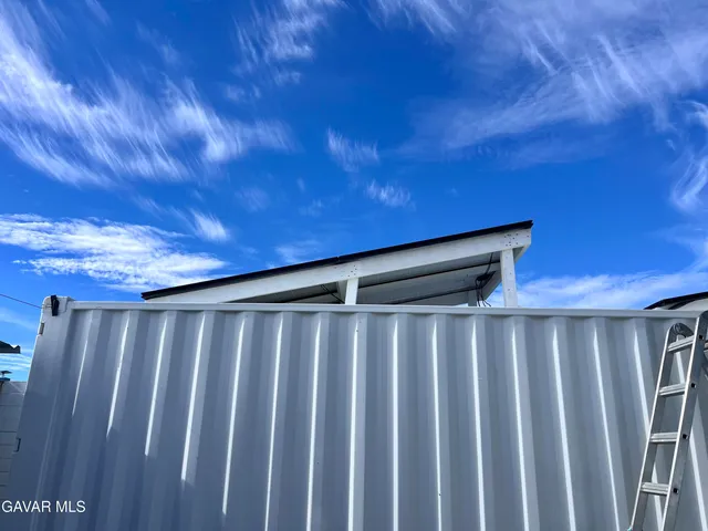 a house view with a sitting space and a backyard space