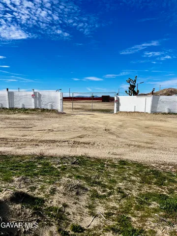 a view of house with backyard and a garden